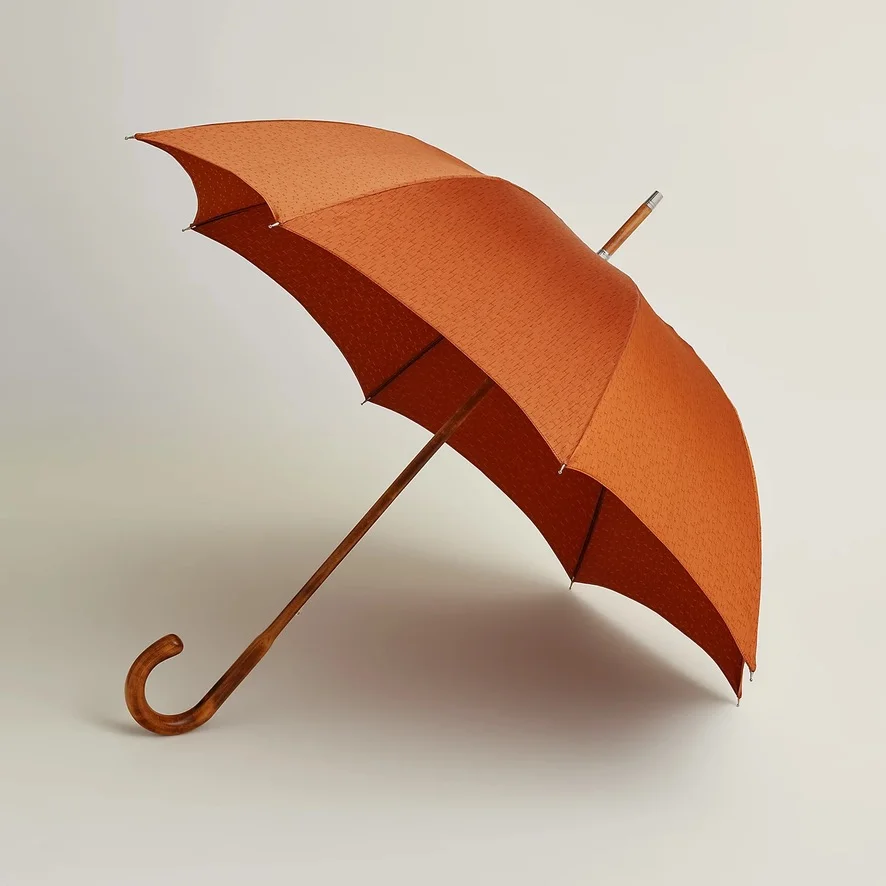 Iconic Pluie de H long umbrella reflecting the premium Hermes umbrella price