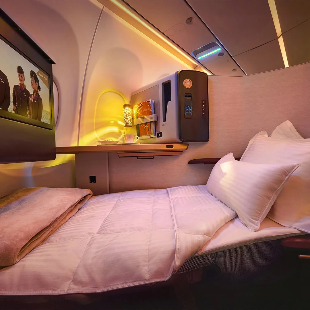High-society passenger preparing to book Etihad Business Class ticket options for a holiday getaway