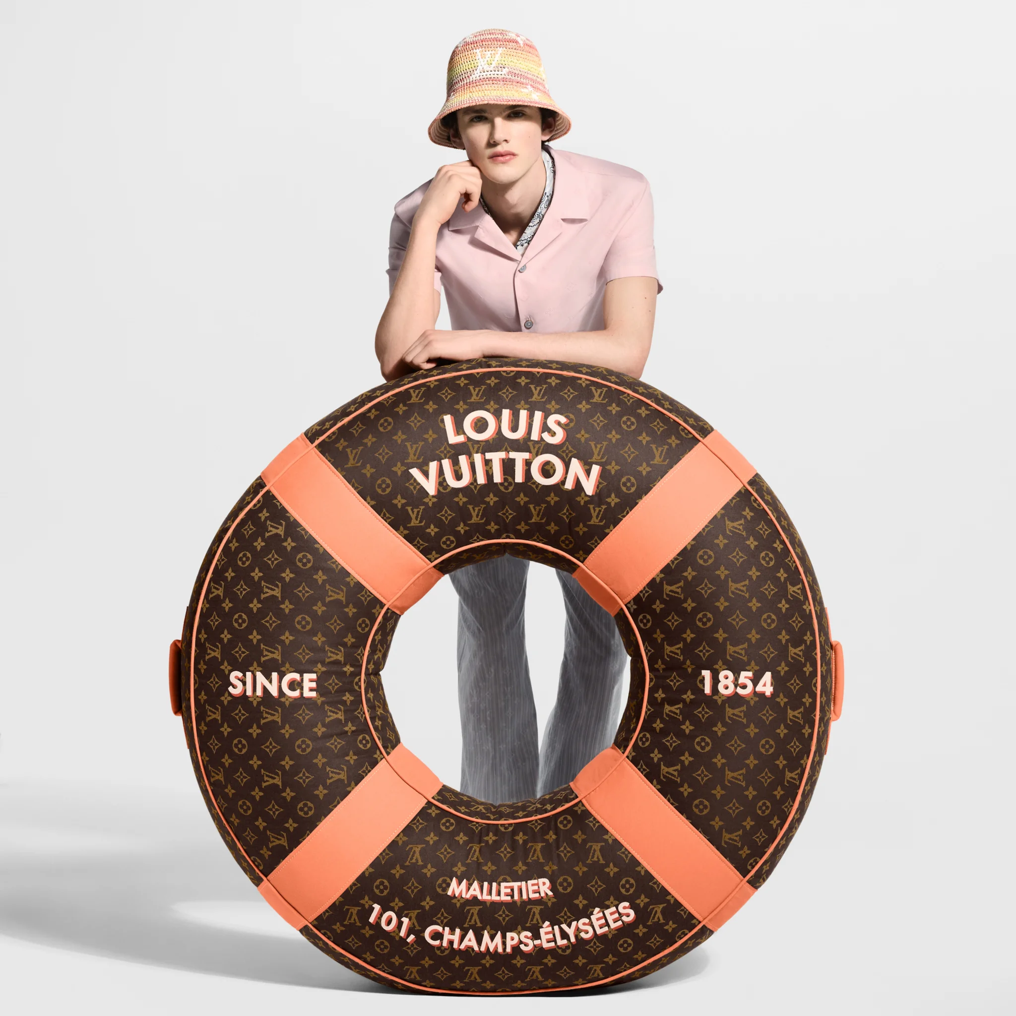Louis Vuitton luxury beach accessory item with pop orange stripes