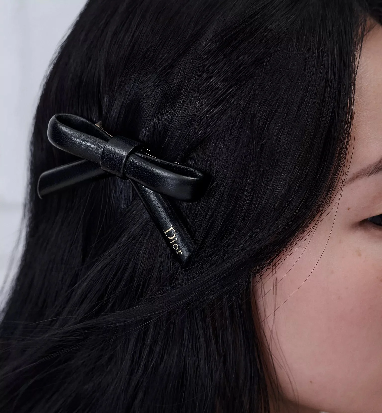 Celine gold-finished brass hair clips paired alongside Louis Vuitton MNG flat clips set
