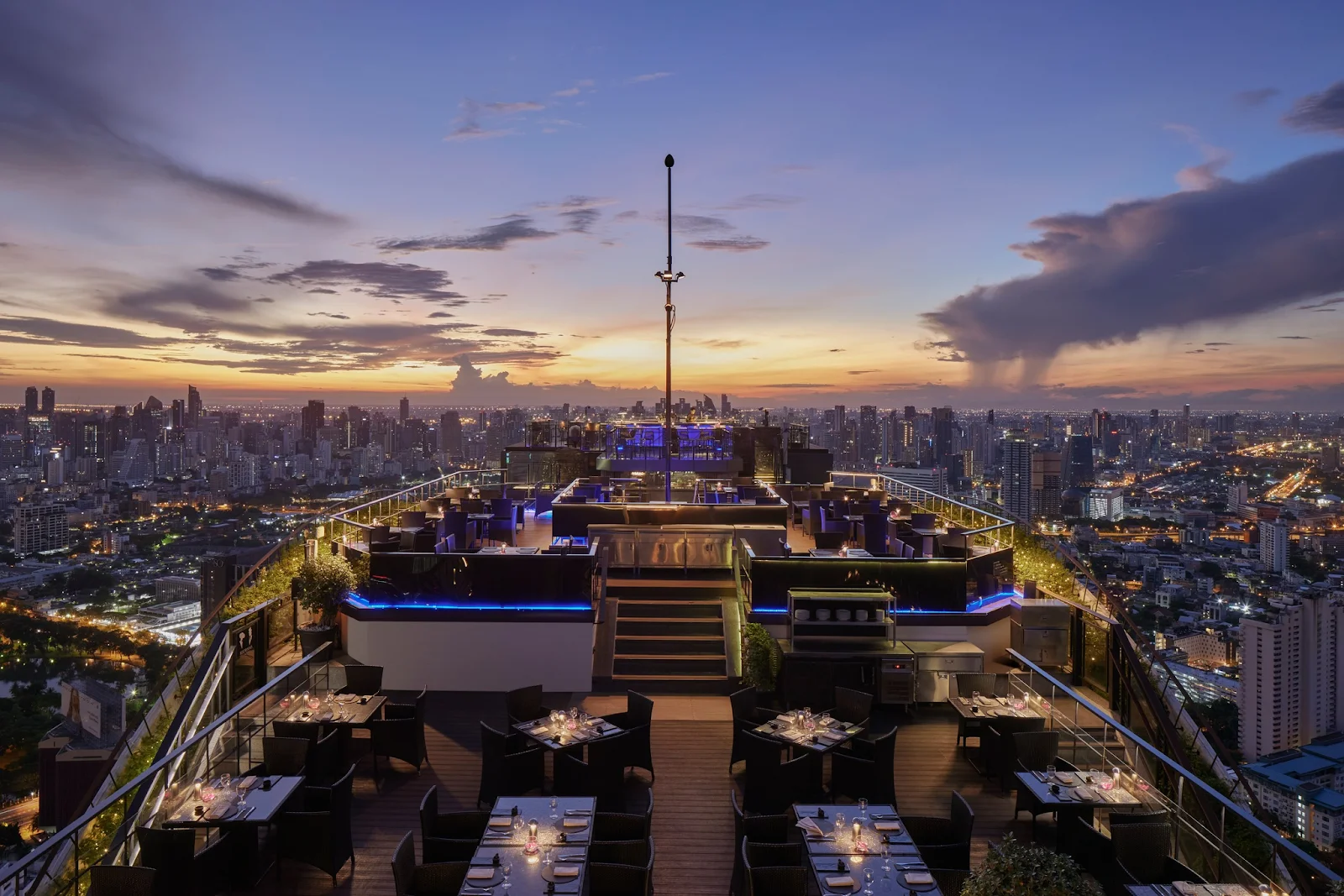 Modern luxury bedroom with city skyline view at Park Hyatt Bangkok